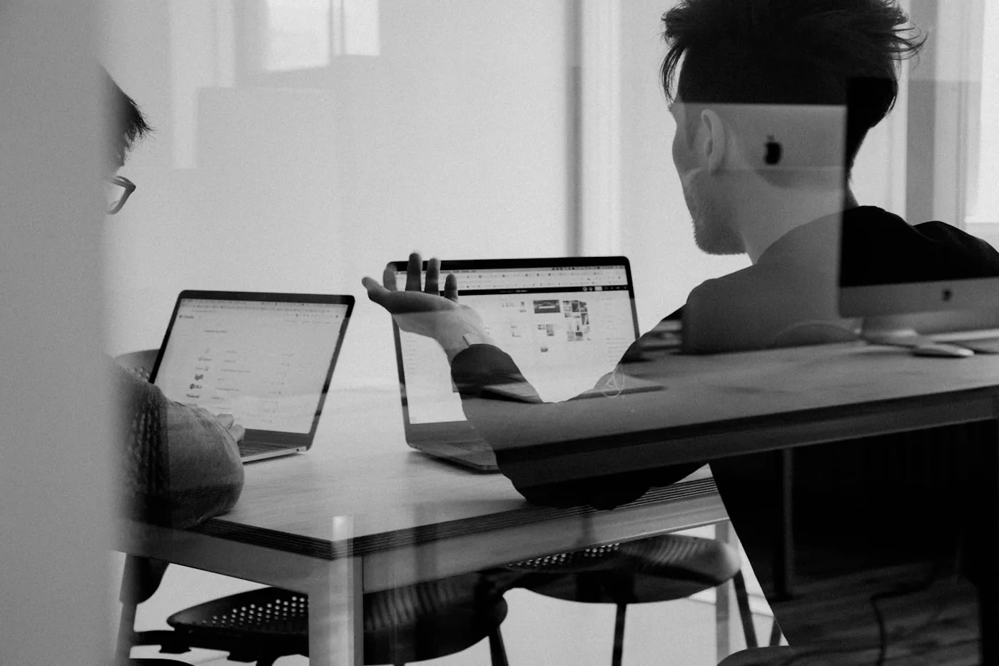 Two people reviewing a product on a laptop in a quiet office