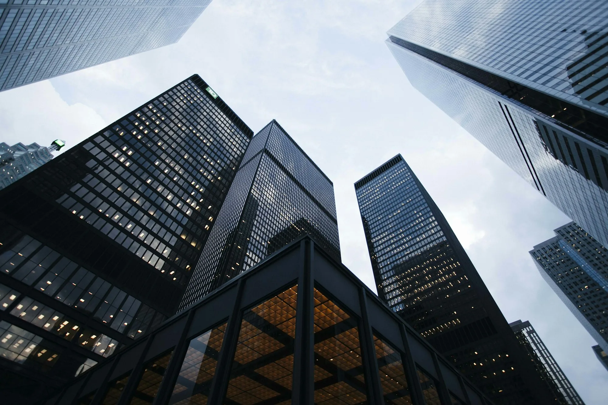 Glass high-rise seen from below against a clear sky